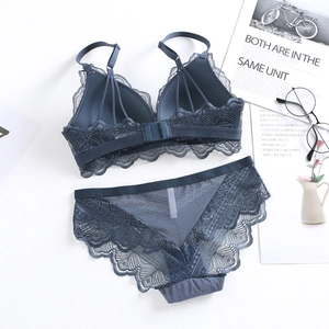 Flat lay of dusty blue wireless lace bra and pantie set with lifestyle props