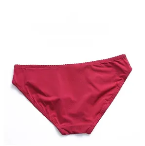 Macro detail of wine red lace panties showing silk-like texture and floral embroidery