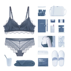 Flat lay of French blue-grey lace lingerie set with matching bra and panties on white