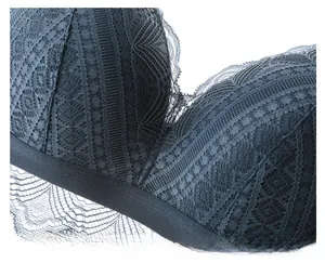 Close-up of grey-blue French lace bra with soft cotton lining and delicate wavy edges