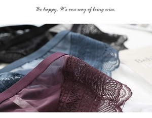 Detailed close-up of lace mesh panties in burgundy, blue and black with sheer texture
