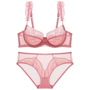 Detailed view of pink floral lace bra set with scalloped edges and bow accents