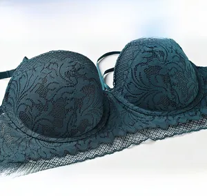 Close-up of deep teal floral lace texture and intricate scalloped edges on bra