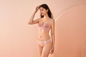 Detail of floral lace bra with lettered shoulder straps and rose pink bow design