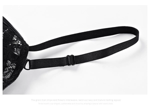 Detail of black lace bra showing intricate floral patterns and adjustable shoulder straps