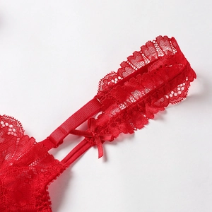 Detailed view of red floral lace bra with elegant satin bow and adjustable straps