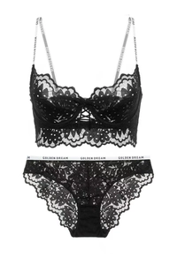 Detail of black floral lace lingerie set featuring logo straps and front lacing design