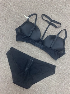 Flat lay of black lace lingerie set with V-neck bra and hollow Y-shaped back straps