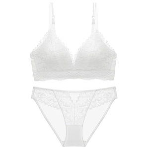 Flat lay of white lace lingerie set with wireless V-neck bra and floral sheer panties