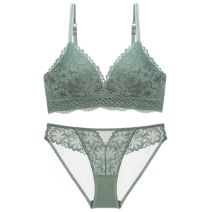 Close-up of light green floral lace bra and panty set with intricate embroidery detail
