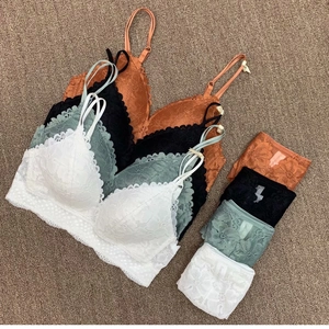 Detailed flat lay of French lace lingerie sets in black, white, green and orange colors