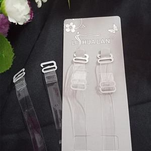 Macro shot of clear invisible TPU bra straps with metal hooks on a black background