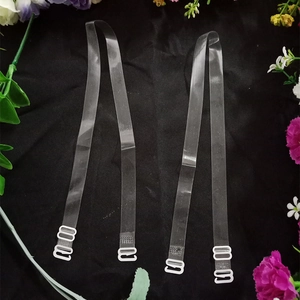 Transparent anti-slip bra straps with adjustable white hooks on black fabric background