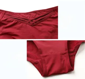 Detail view of dark red mid-waist briefs with elastic cross strap design and soft gusset