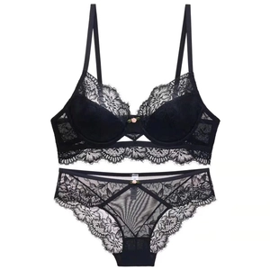Detailed close-up of a black floral lace lingerie set with elegant eyelash lace trim
