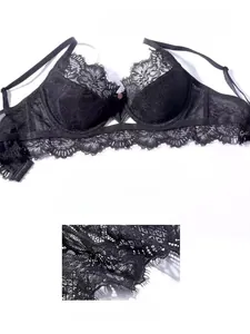 Detailed view of black eyelash lace bra featuring delicate pink flower and sheer embroidery