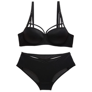 Elegant black lingerie set with push-up bra and strappy detailing on a white background
