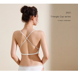 Detail view showing white triangle cup bra with U-shaped back and thin cross straps