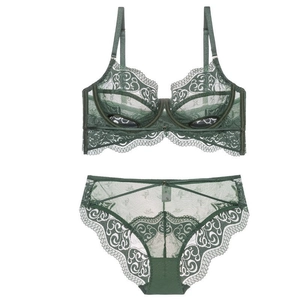 Detail of dark green lace lingerie set with sheer mesh and floral embroidery patterns