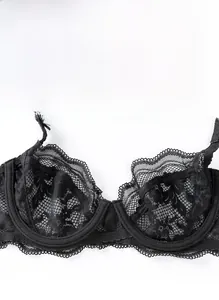 Close-up of black floral lace bra cup showing intricate mesh details and scalloped edges