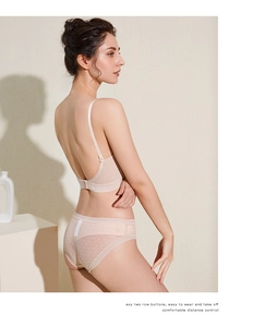 Detail view of skin-tone backless bra with double-row hooks and dotted mesh panties