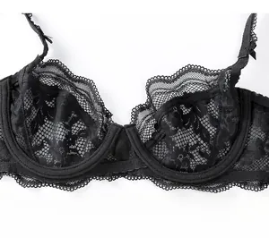 Close-up of black lace bra detail showing intricate mesh patterns and floral lace straps