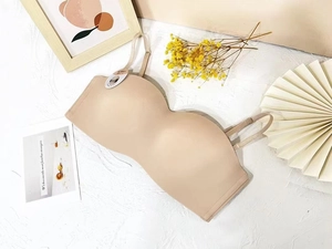 Detailed close-up of a seamless beige bandeau bra on a stylish minimalist background