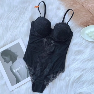 Close-up of black lace bodysuit featuring floral embroidery and mesh paneling
