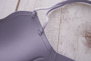 Close-up of seamless light purple bra showing elastic straps and bonded edge details