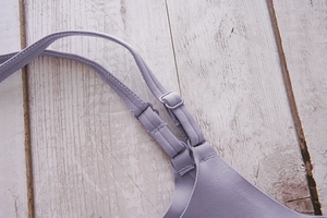 Detail of adjustable shoulder strap and seamless stitching on a lavender V-neck bra