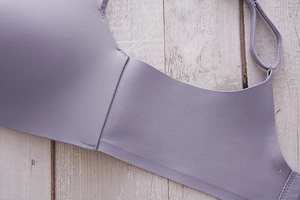 Close-up of lavender seamless bra with adjustable straps and smooth texture finish