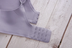 Detail of four-row hook and eye closure on seamless lavender wireless deep V bra