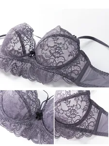 Detailed view of floral lace pattern with ruffle trim and bow on lilac bra cups