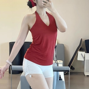 Detail of V-neck halter sports top and side drawstring gym shorts in a studio
