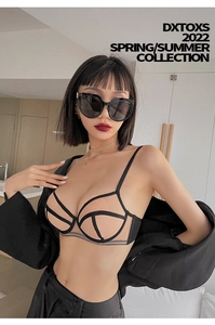 Detail of black cutout mesh lingerie set paired with a stylish black satin blazer