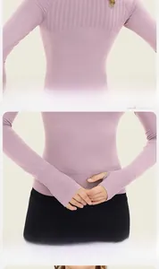 Detail of pink long sleeve gym top with breathable mesh panel and thumb holes