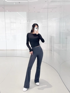Mirror selfie showing high waist flared yoga pants and tight long sleeve top