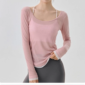 Detailed texture of pink breathable mesh yoga top with sheer long sleeves for women