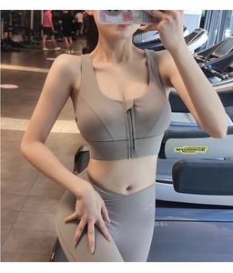 Detailed view of the front zipper sports bra and high-waist yoga leggings in taupe grey