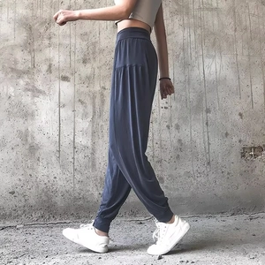 High-waist loose yoga joggers in blue-grey fabric with elastic cuffs and harem style