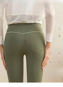 Detail view of olive green high waist yoga pants with peach lift effect and back pockets