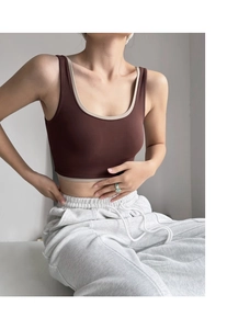 Detail of high-impact yoga sports bra with contrast piping and a deep U-neckline