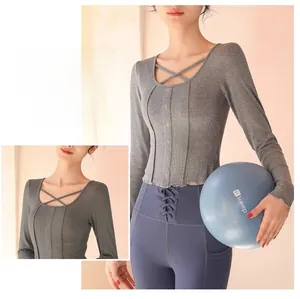 Close-up of dark grey yoga top featuring a U-neck with criss-cross hollow out and ribbed texture