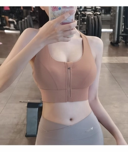 Detailed close-up of high-impact sports bra with front zipper and wide straps in dusty rose