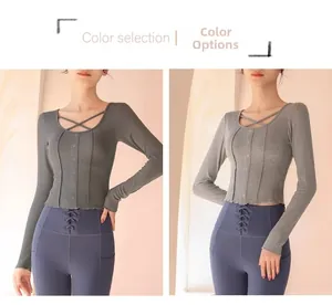 Detail of slim fit yoga top with criss-cross neck and button trim in grey options