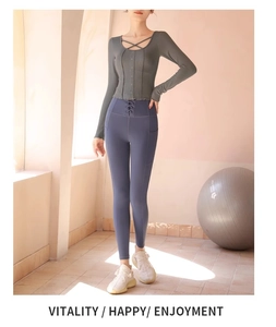 Detail of grey ribbed long sleeve yoga top with button front and blue high waist leggings