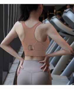 High-impact sports bra detail with racerback cutout design in a gym setting