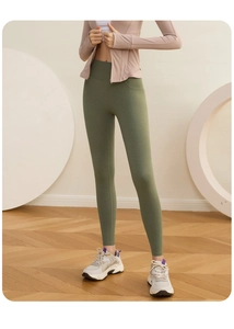 Detail of high-waisted olive green yoga pants showing tummy control and seamless compression
