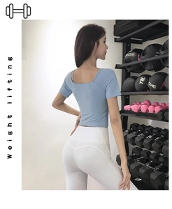 Detail of light blue short sleeve yoga top with square neck and breathable fabric
