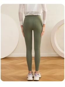 Detail view of olive green high-waisted gym leggings with back pockets and contouring fit